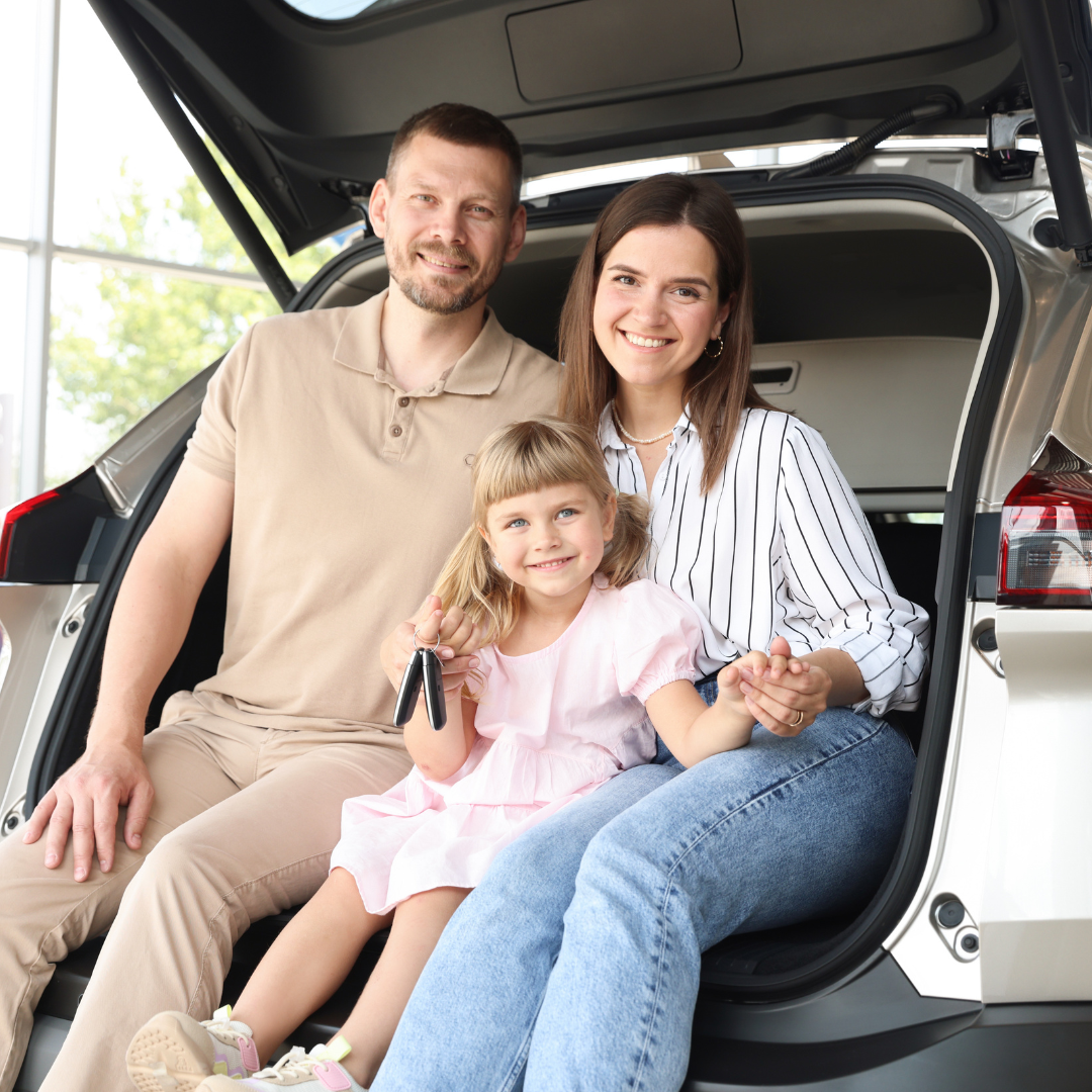 Happy family sitting in a vehicle